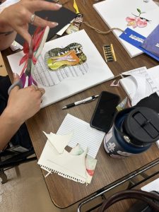 A student creates a collage art project