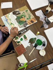 A student creates collage art.