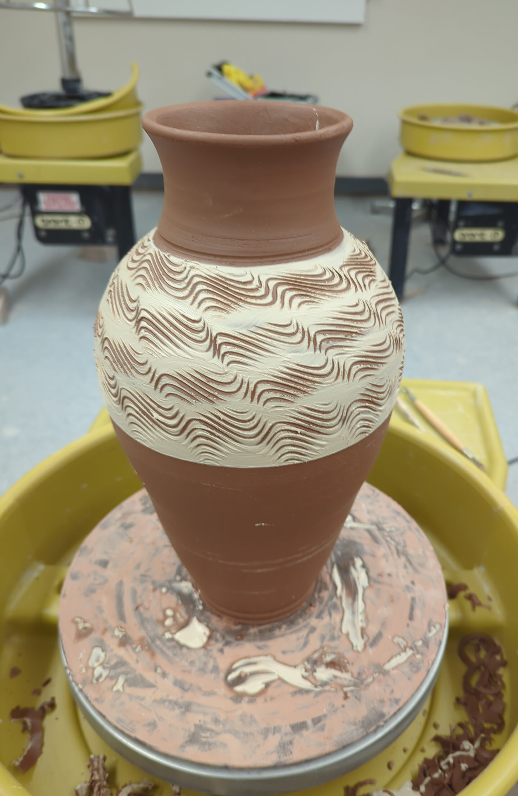 Tall Ceramic vase sitting on wheel